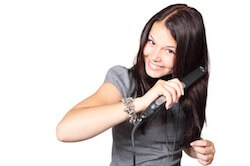 girl straightening hair